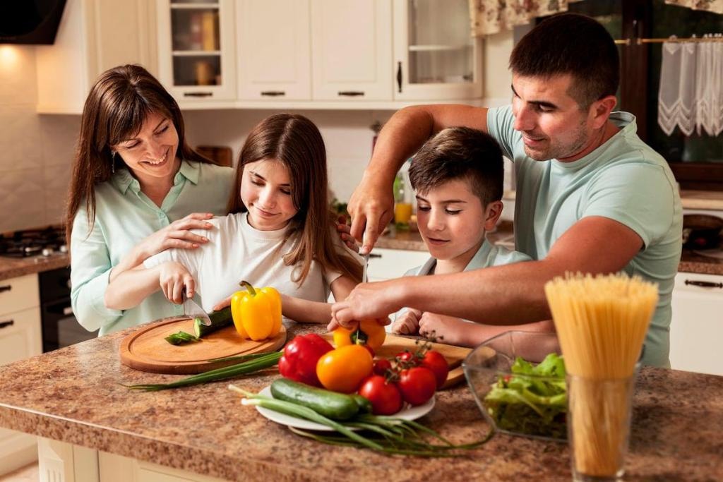 Family preparing fresh vegetables together in a kitchen